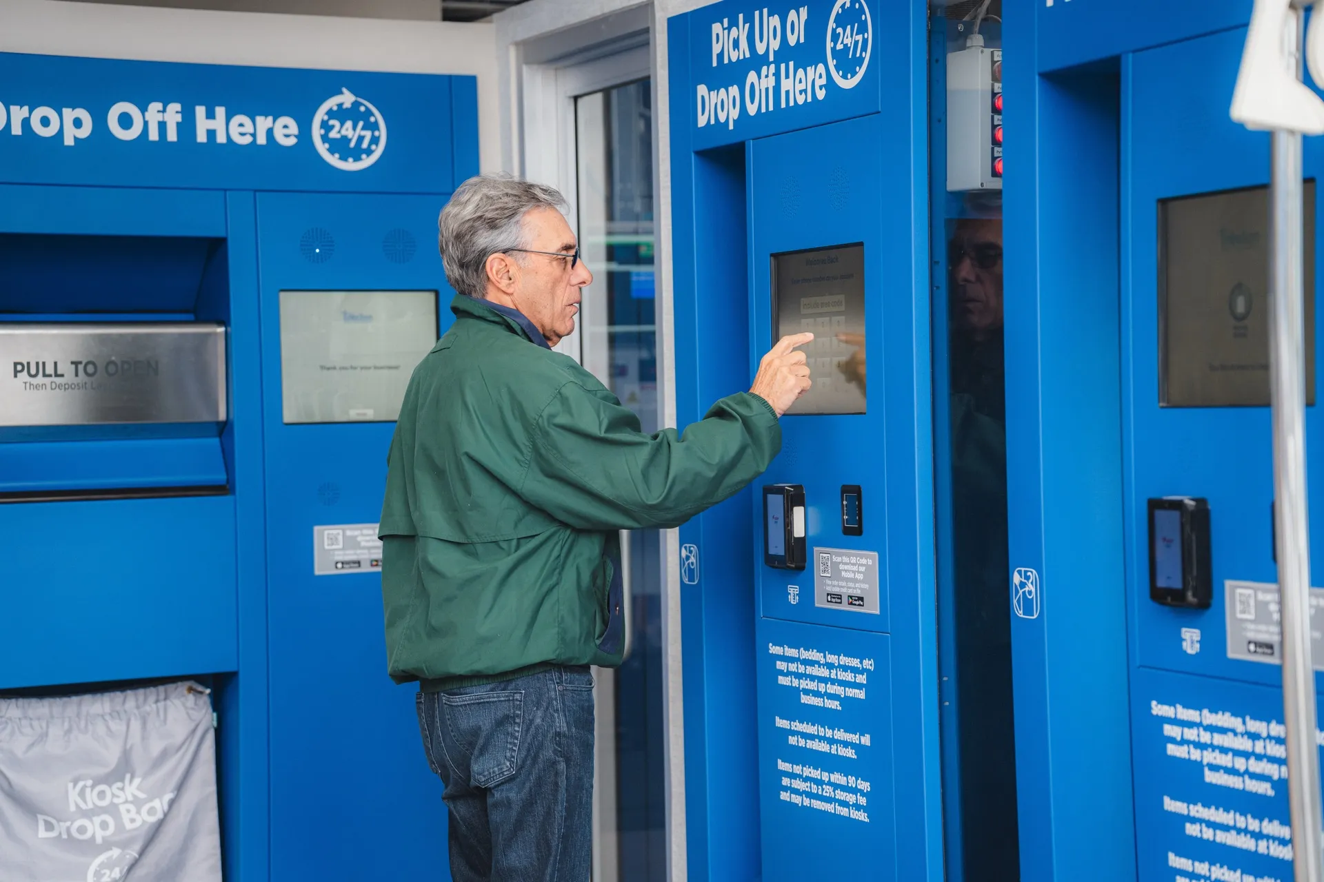Customer using the touchscreen on a Tres Bon 24/7 kiosk