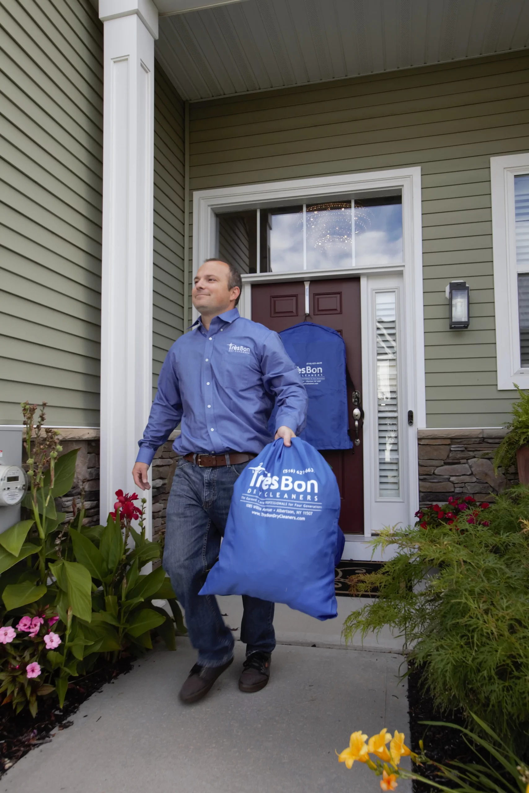 Tres Bon driver delivering a garment bag to a customer’s front door