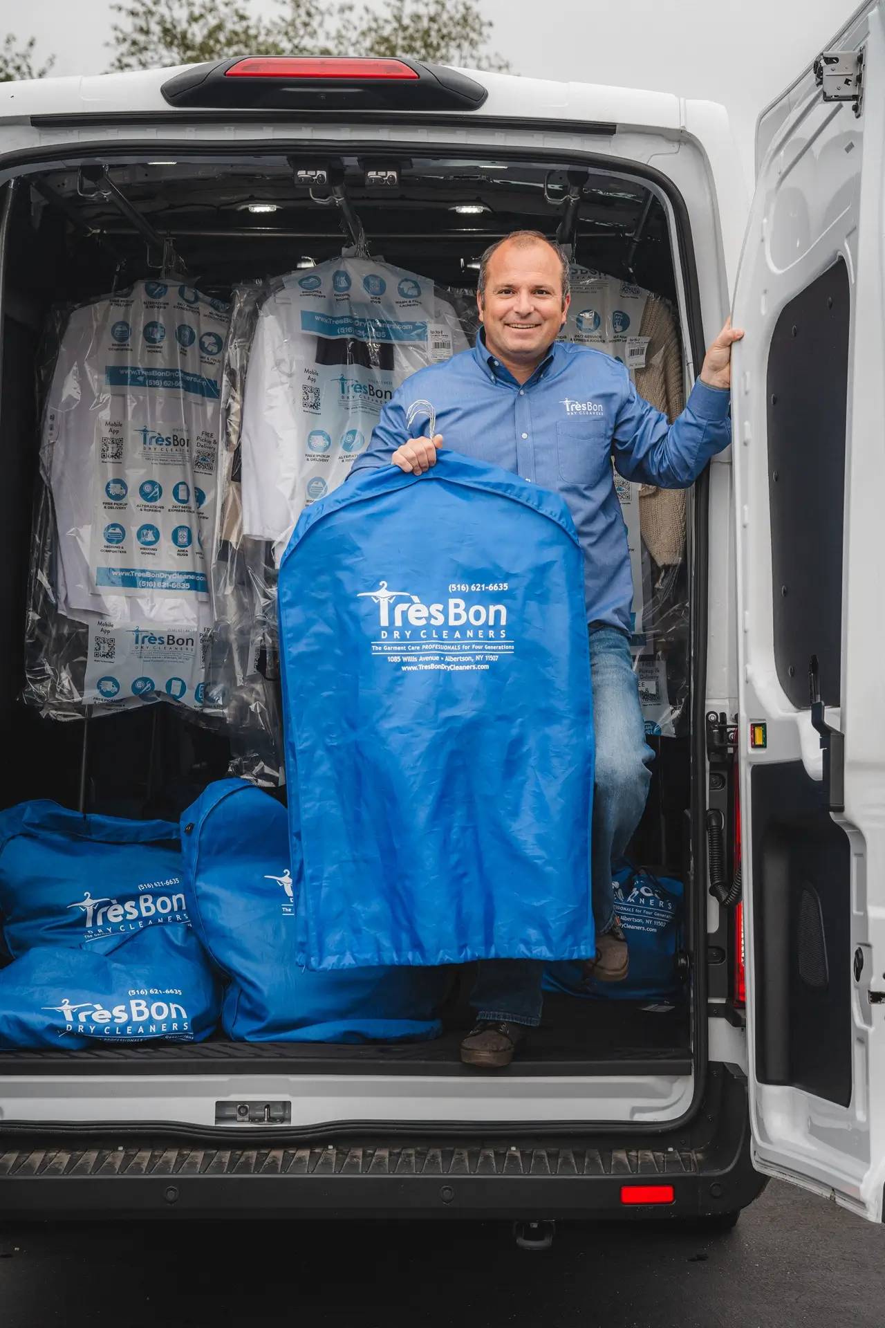 Tres Bon driver with clean garments in the delivery van